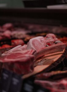 A variety of fresh raw meats on display at a stall in Stralsund market, Germany.